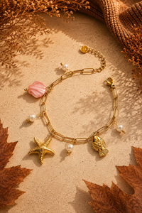 Gouden Coco armband van Fencyjewels met zeester, schelp, roze en parelmoer bedels.