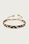 Ibiza armband van Fencyjewels – handgemaakte kralenarmband met zwart, wit en goud patroon, verstelbare sluiting en gouden details, stijlvolle boho armband voor dames.