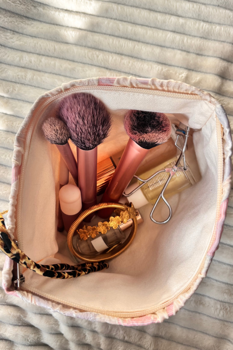 Fency Toilettas van Fencyjewels in roze bloemenprint, gevuld met make-upkwasten, parfumflesje, sieraden en beauty accessoires, ideaal om sieraden en cosmetica stijlvol te bewaren.