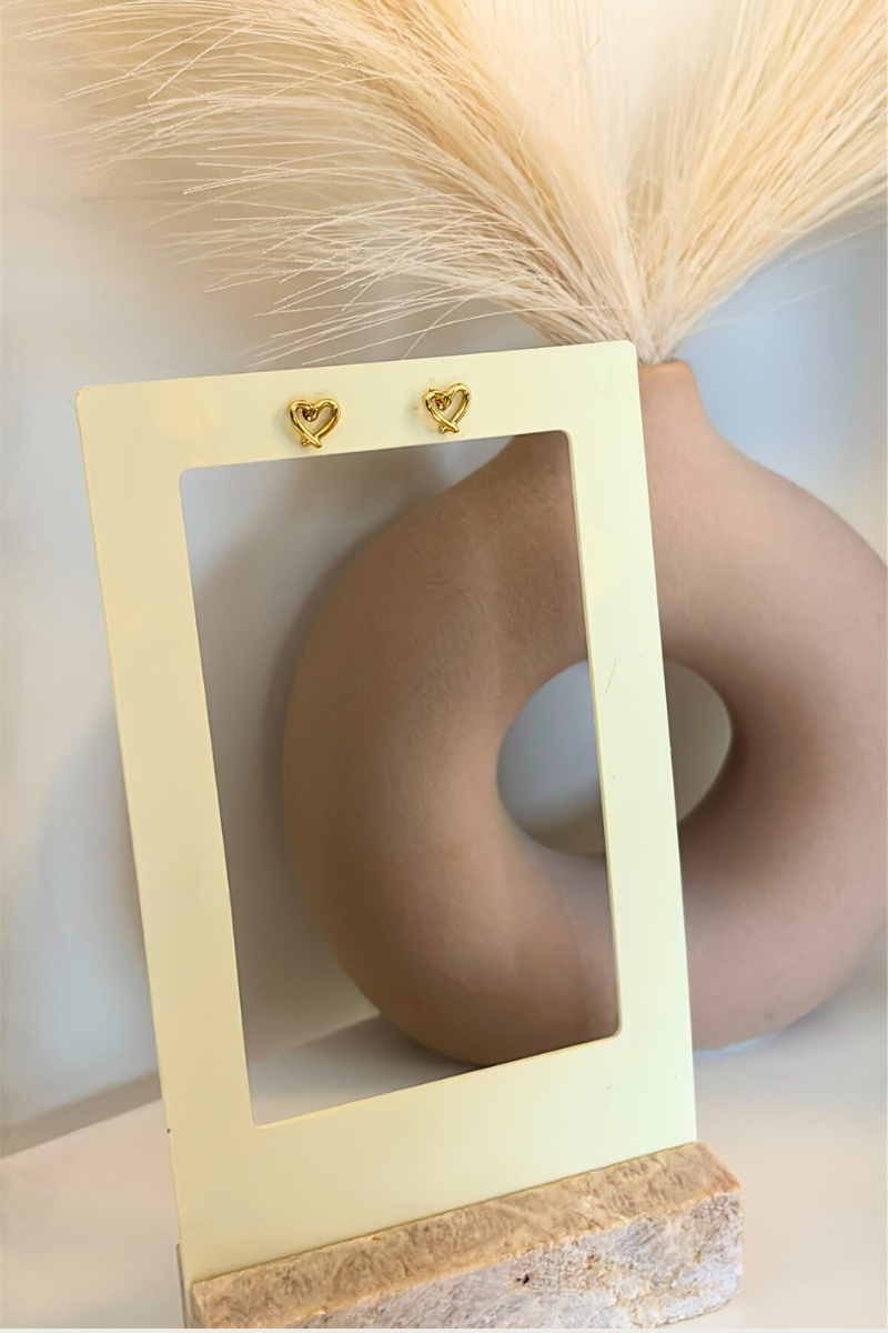 Small open heart studs van Fencyjewels in goudkleur op display. Minimalistische oorbellen met open hartje, gemaakt van stainless steel en perfect voor dagelijks gebruik.